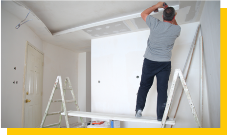 drylining contractor installing ceiling