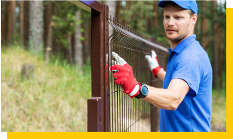 fencing contractor erecting steel fence panel